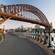 A harborside walkway traveling under the Sydney Harbour Bridge